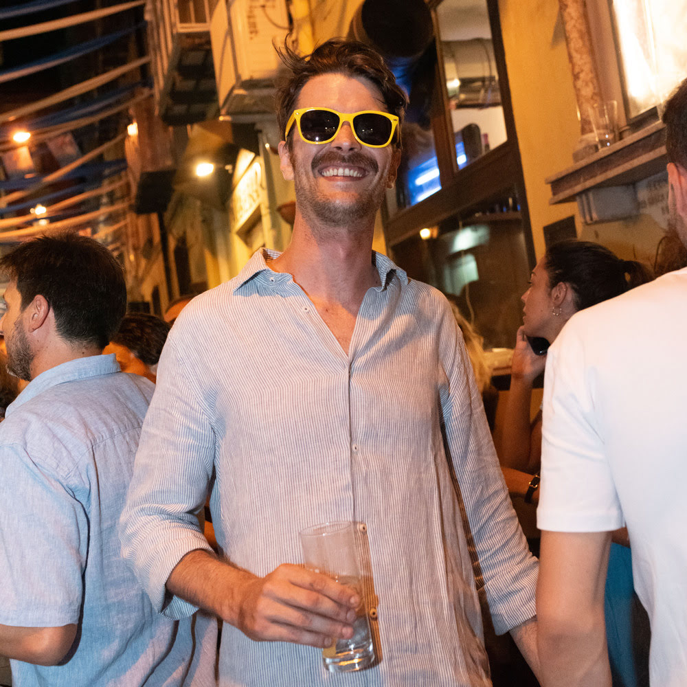 A guy wearing yellow Mosto sunglasses on a night out