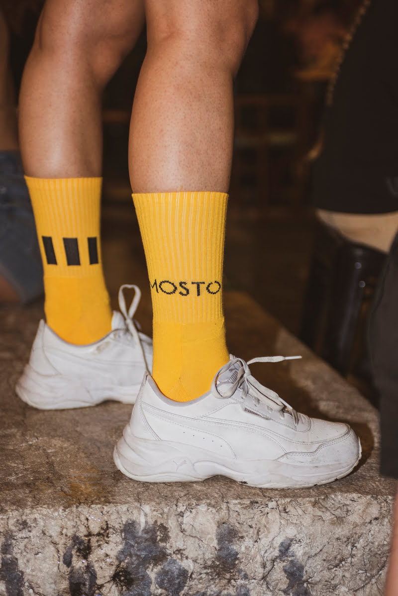 Feet in yellow Mosto socks on a step